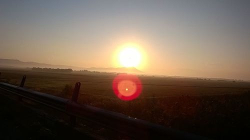 Scenic view of field against sky during sunset