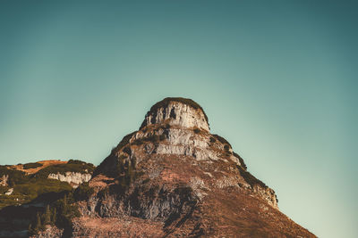 Low angle view of rock formation against sky