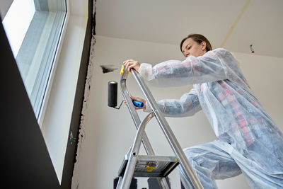 Portrait of young woman sitting on escalator