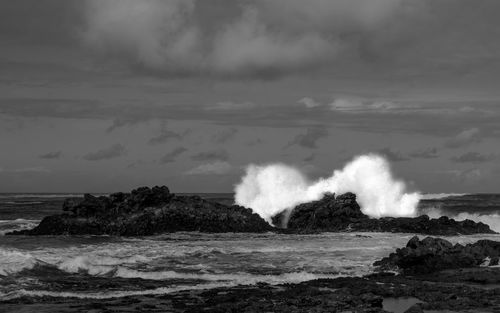 Scenic view of sea against sky with waves crushing on the shore 