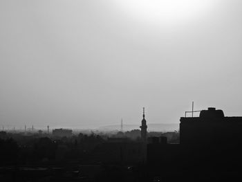 Silhouette of city against clear sky