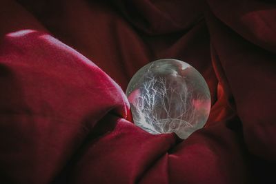 Crystal ball on red fabric