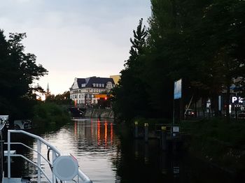 Boats in city against sky