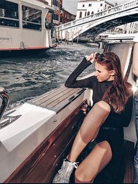 Woman sitting on a boat in sea