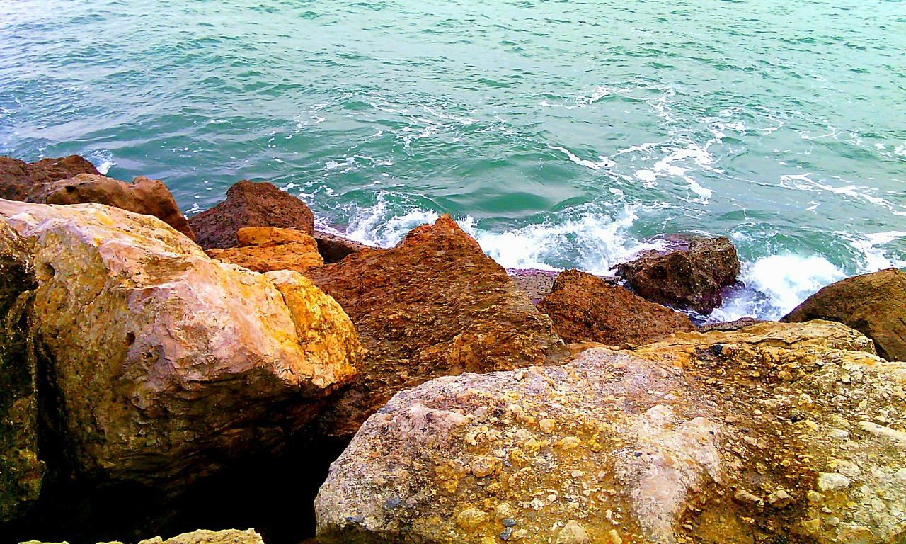 water, sea, rock - object, high angle view, nature, tranquility, beauty in nature, rock formation, tranquil scene, scenics, rippled, shore, rock, sunlight, beach, outdoors, wave, day, idyllic, no people