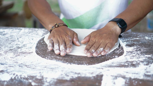 Close-up of man preparing food on table