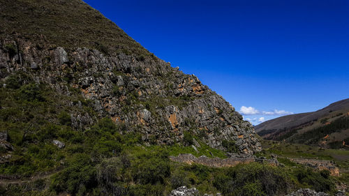 Scenic view of rocky mountains against clear blue sky