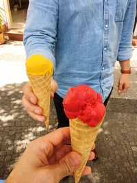 Midsection of person holding ice cream