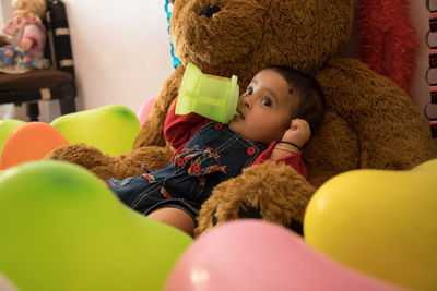 Portrait of cute baby girl with toy at home