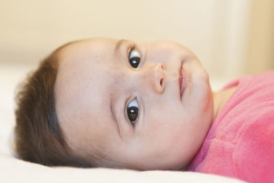 Close-up portrait of cute baby lying