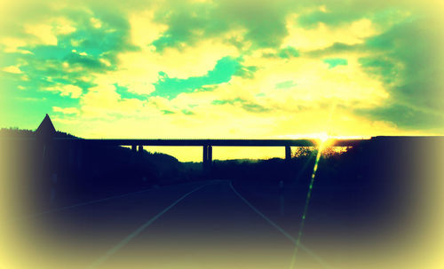 Silhouette bridge against sky during sunset