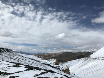 Scenic view of snow covered mountains against sky