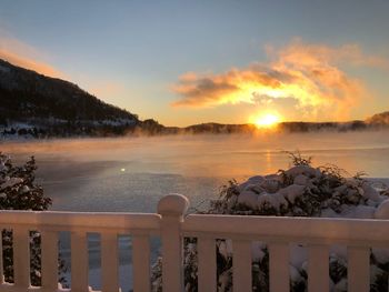 Scenic view of lake against sky during sunset