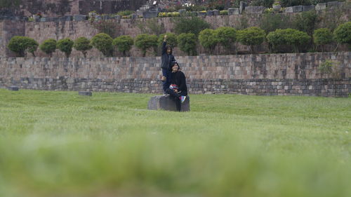 View of people sitting on field