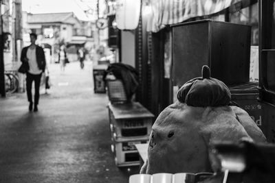 Rear view of man walking on street in city