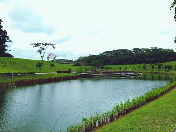 Scenic view of lake against cloudy sky