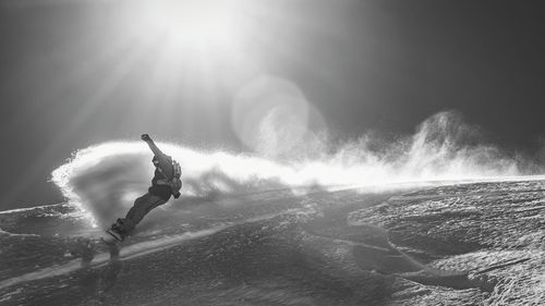 Snowboarder jumps from cliff of snow