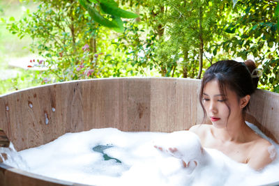 Side view of young woman in bathtub