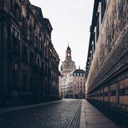 Street amidst buildings in city against sky