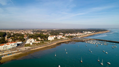 High angle view of sea and buildings against sky