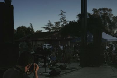 Woman standing by railing in city