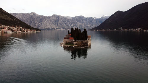 Scenic view of lake and mountains against sky