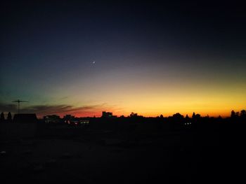 Silhouette landscape against clear sky at night