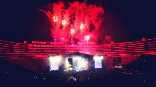 Panoramic view of crowd at concert against sky at night