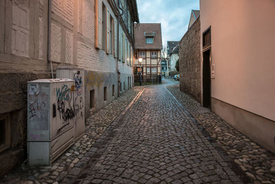 Empty alley amidst buildings in city