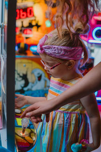 Little girl looking at the claw machine