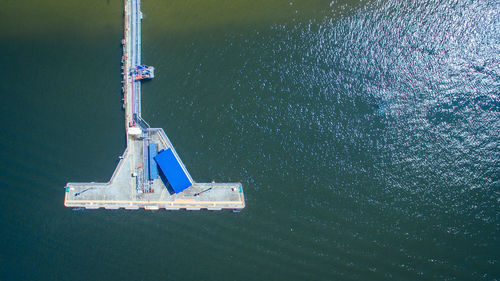 High angle view of crane against blue sea