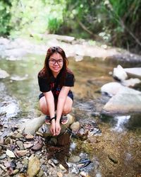 Portrait of young woman with reflection in water