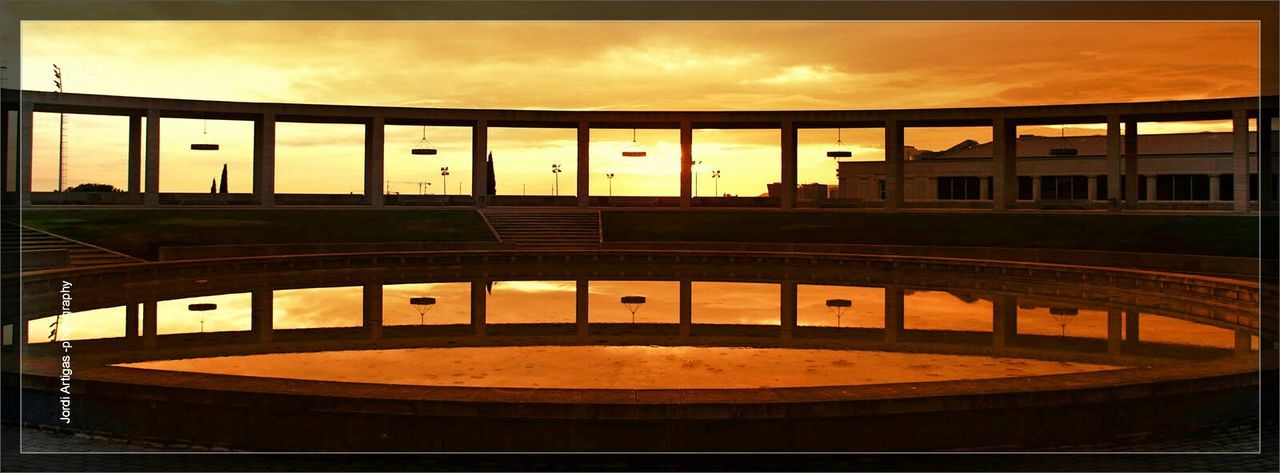 architecture, sunset, built structure, sky, transfer print, cloud - sky, auto post production filter, building exterior, orange color, cloud, cloudy, no people, dusk, transportation, outdoors, railing, illuminated, building, dramatic sky, silhouette