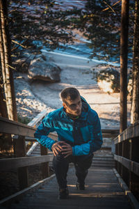 Side view of man sitting on steps