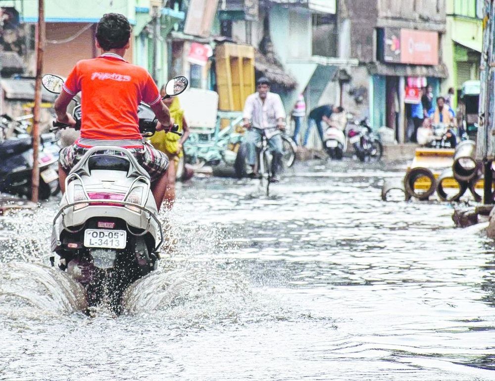 transportation, mode of transportation, street, city, land vehicle, men, architecture, incidental people, real people, wet, day, water, group of people, building exterior, built structure, road, rear view, motion, waterfront, outdoors, riding, rain