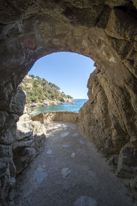 Scenic view of rocky beach against clear sky