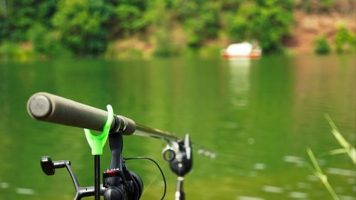 Close-up of bicycle wheel by lake