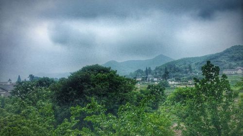 Scenic view of mountains against cloudy sky