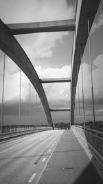 Road by bridge against sky