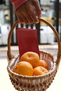 Midsection of woman holding orange during chinese new year