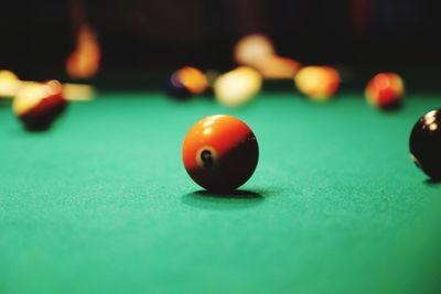 Close-up of cue balls on pool table