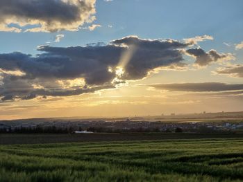 Scenic view of field against sky during sunset