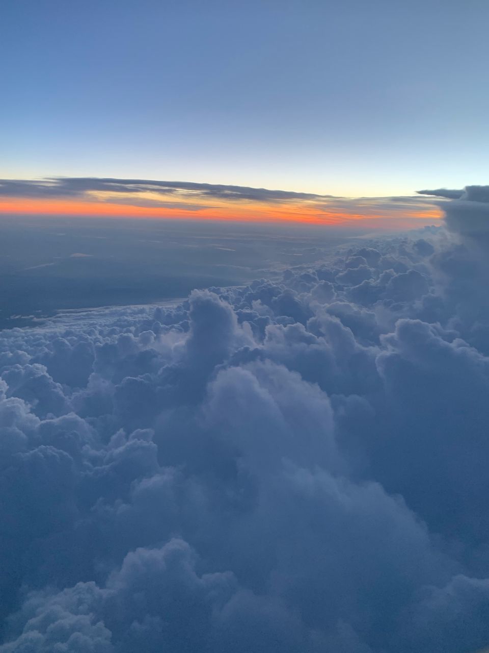 AERIAL VIEW OF CLOUDS OVER LANDSCAPE DURING SUNSET