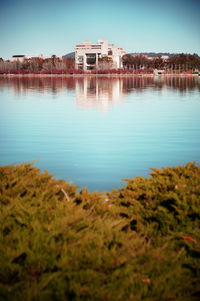 Calm blue sea with buildings in background