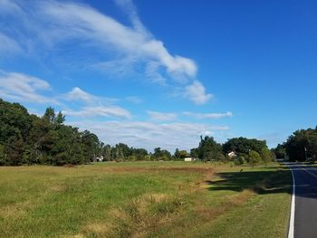 Empty country road against blue sky