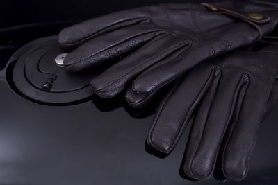 High angle view of leather gloves on motorcycle