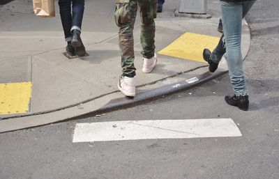 Low section of people walking on road