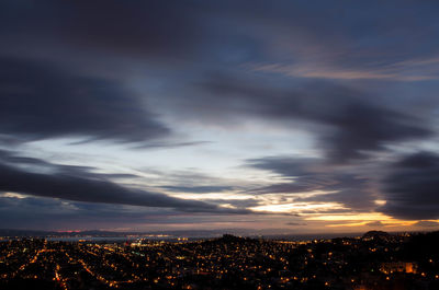 Aerial view of city against cloudy sky