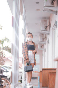 Full length of young woman standing in gym