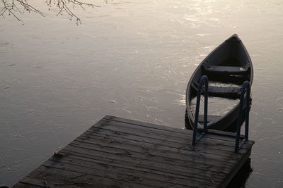 High angle view of boat moored by pier over lake